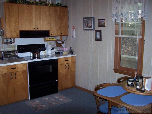 355 Trout Lake Road Deep Gap, NC 28618 - Photo 3 of 45 a kitchen with a sink cabinets and a stove