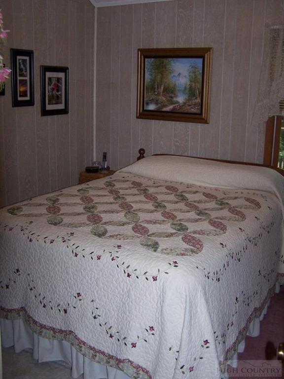 355 Trout Lake Road Deep Gap, NC 28618 - Photo 4 of 45 a bedroom with a bed and painting on the wall