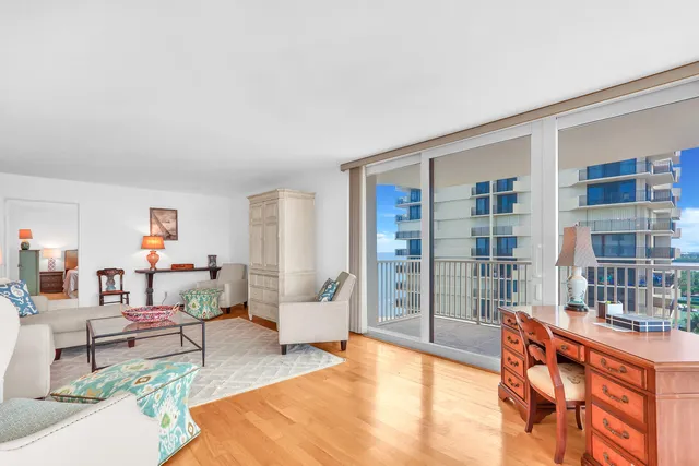 a living room with furniture a rug and a window
