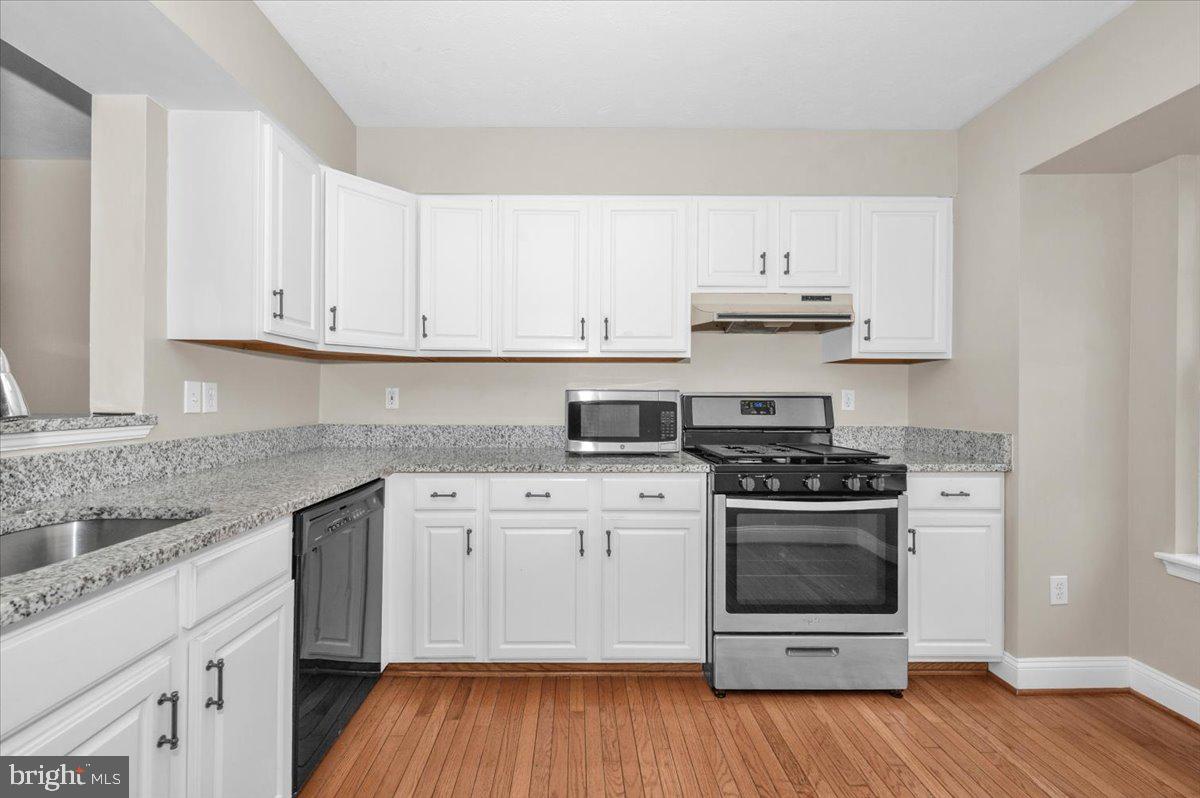 1184 Heathfield Road Sykesville, MD 21784 - Photo 7 of 56 a kitchen with stainless steel appliances granite countertop a stove and white cabinets