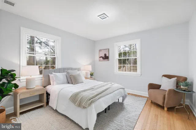 a bedroom with bed and wooden floor