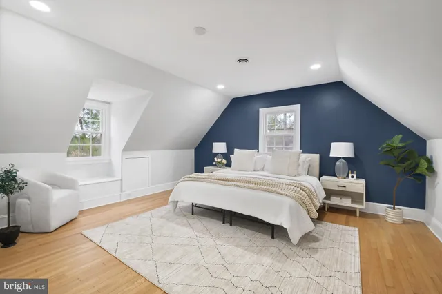 a spacious bedroom with a bed and a couch