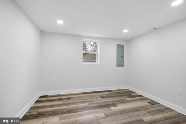 a view of a room with wooden floor and window