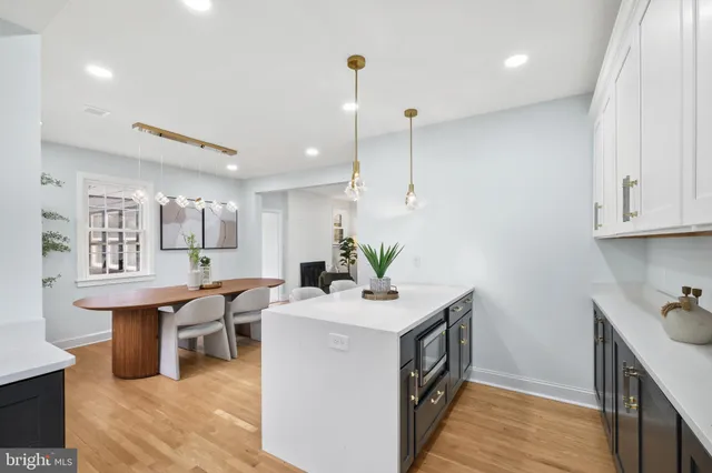 a kitchen with sink a table and chairs