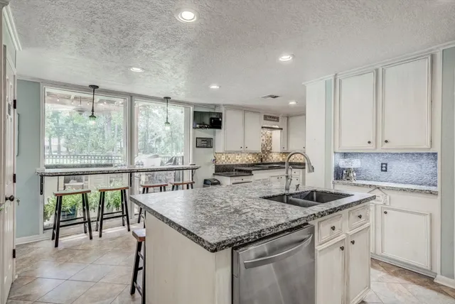 a utility room with cabinets washer and dryer