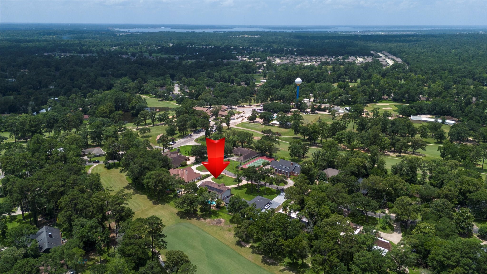 22 Winged Foot Drive Conroe, TX 77304 - Photo 2 of 49 a view of a houses with a lush green forest