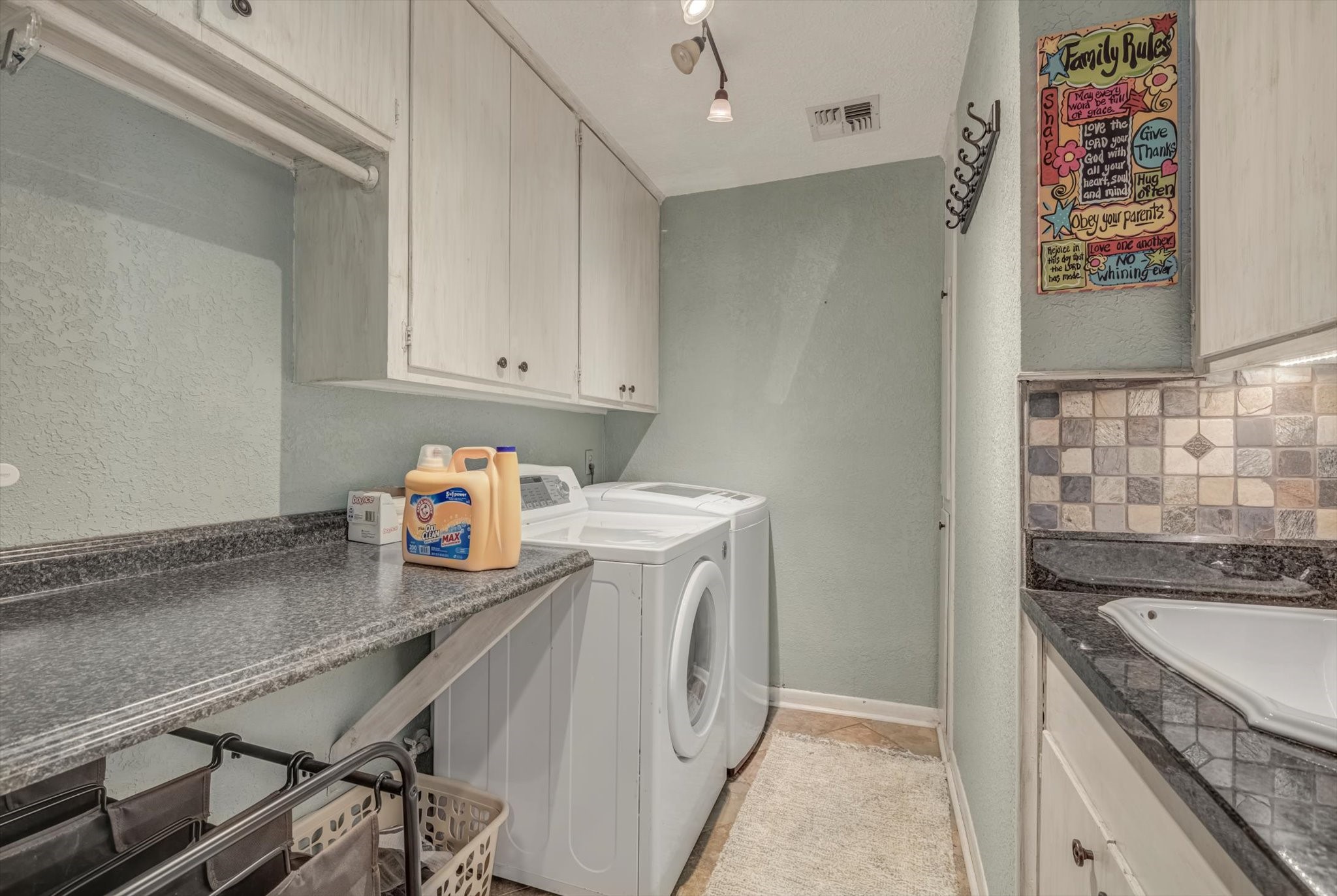 22 Winged Foot Drive Conroe, TX 77304 - Photo 21 of 49 a utility room with cabinets washer and dryer