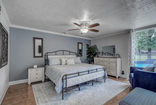a bedroom with a large bed and a chandelier