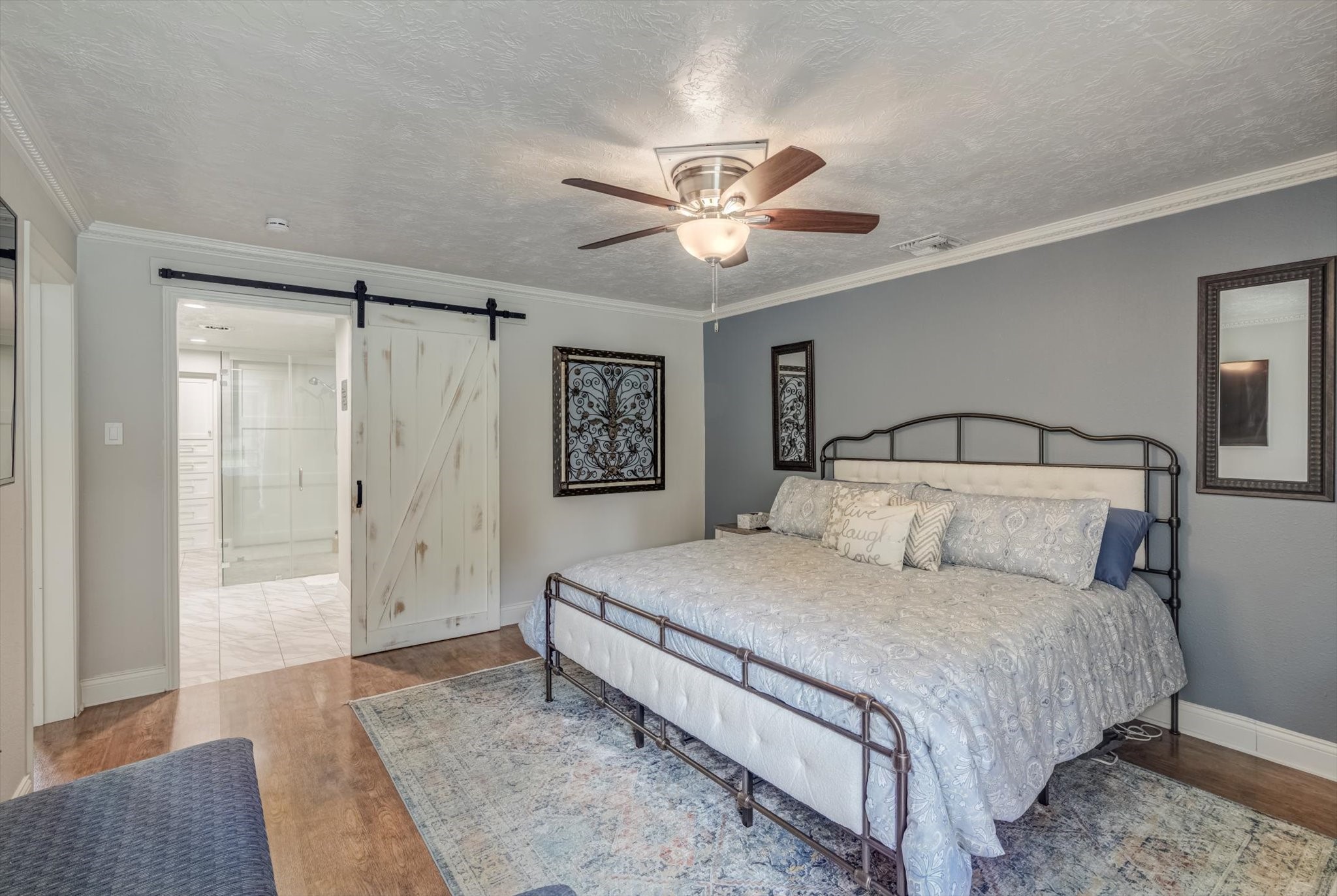 22 Winged Foot Drive Conroe, TX 77304 - Photo 25 of 49 a bedroom with a large bed and a chandelier