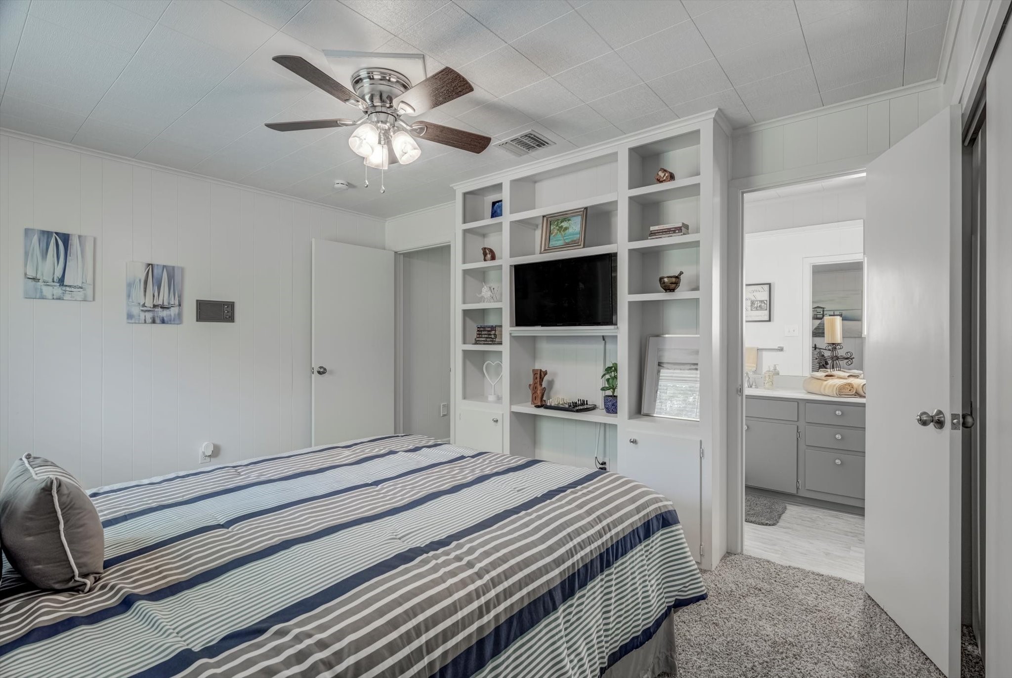 22 Winged Foot Drive Conroe, TX 77304 - Photo 37 of 49 a bedroom with a bed and a flat screen tv