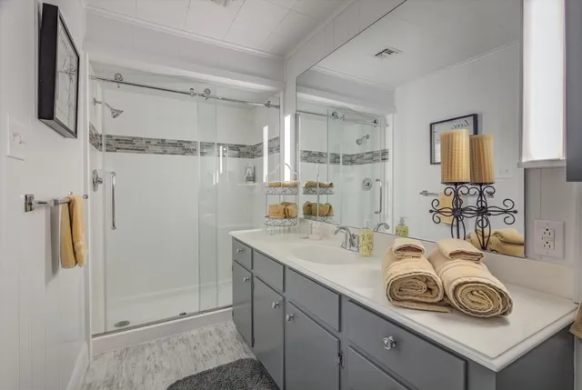a bathroom with a sink vanity and mirror