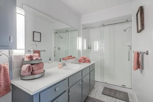 a view of swimming pool with seating space and wooden fence