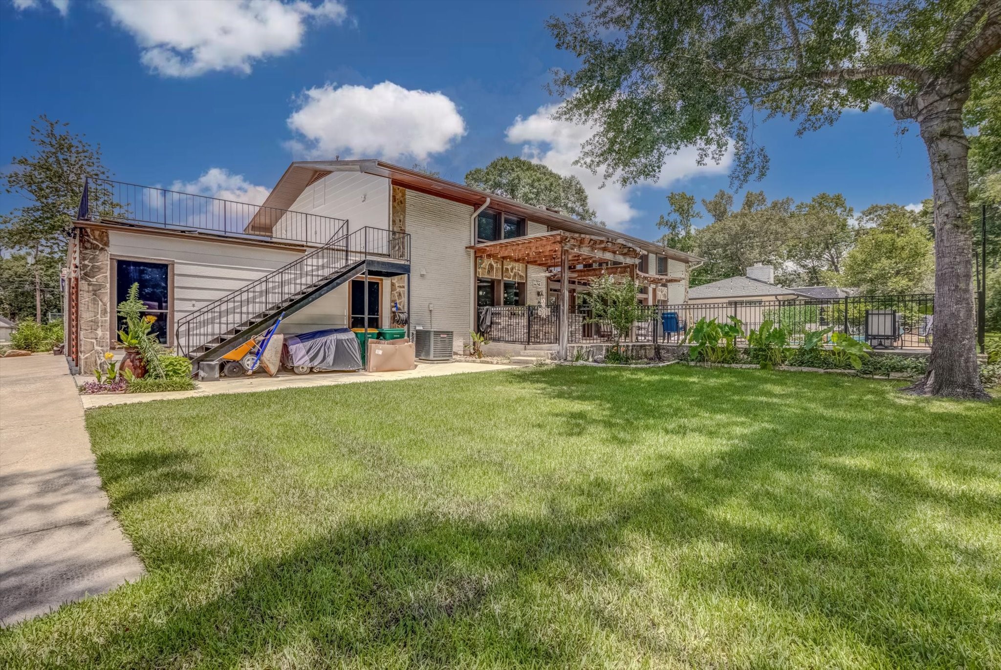 22 Winged Foot Drive Conroe, TX 77304 - Photo 49 of 49 a view of a house with a big yard and potted plants
