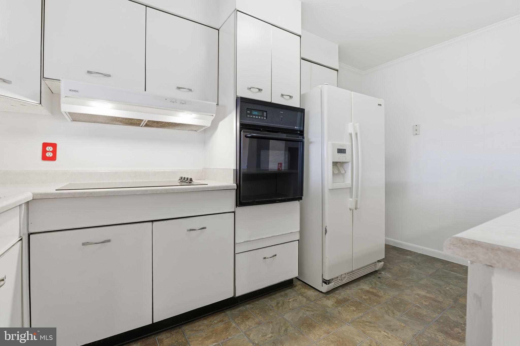 4008 Rock Run Road Havre de Grace, MD 21078 - Photo 5 of 28 a kitchen with white cabinets and white appliances