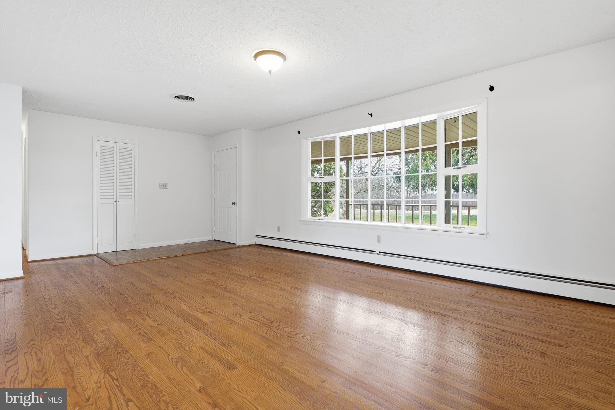 4008 Rock Run Road Havre de Grace, MD 21078 - Photo 7 of 28 a view of an empty room with wooden floor and a window