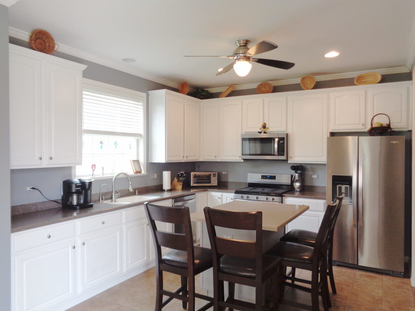 2521 Rolling Ridge Elgin, IL 60124 - Photo 3 of 16 a kitchen with stainless steel appliances granite countertop a dining table chairs refrigerator and microwave