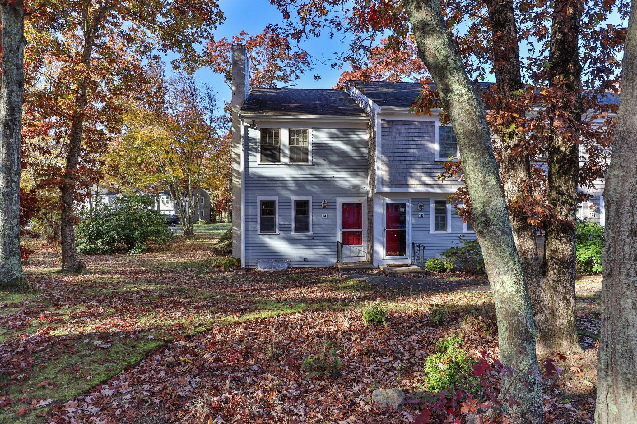 300 Falmouth Road, Unit 1A Mashpee, MA 02649 - Photo 3 of 29 a view of a house with a yard