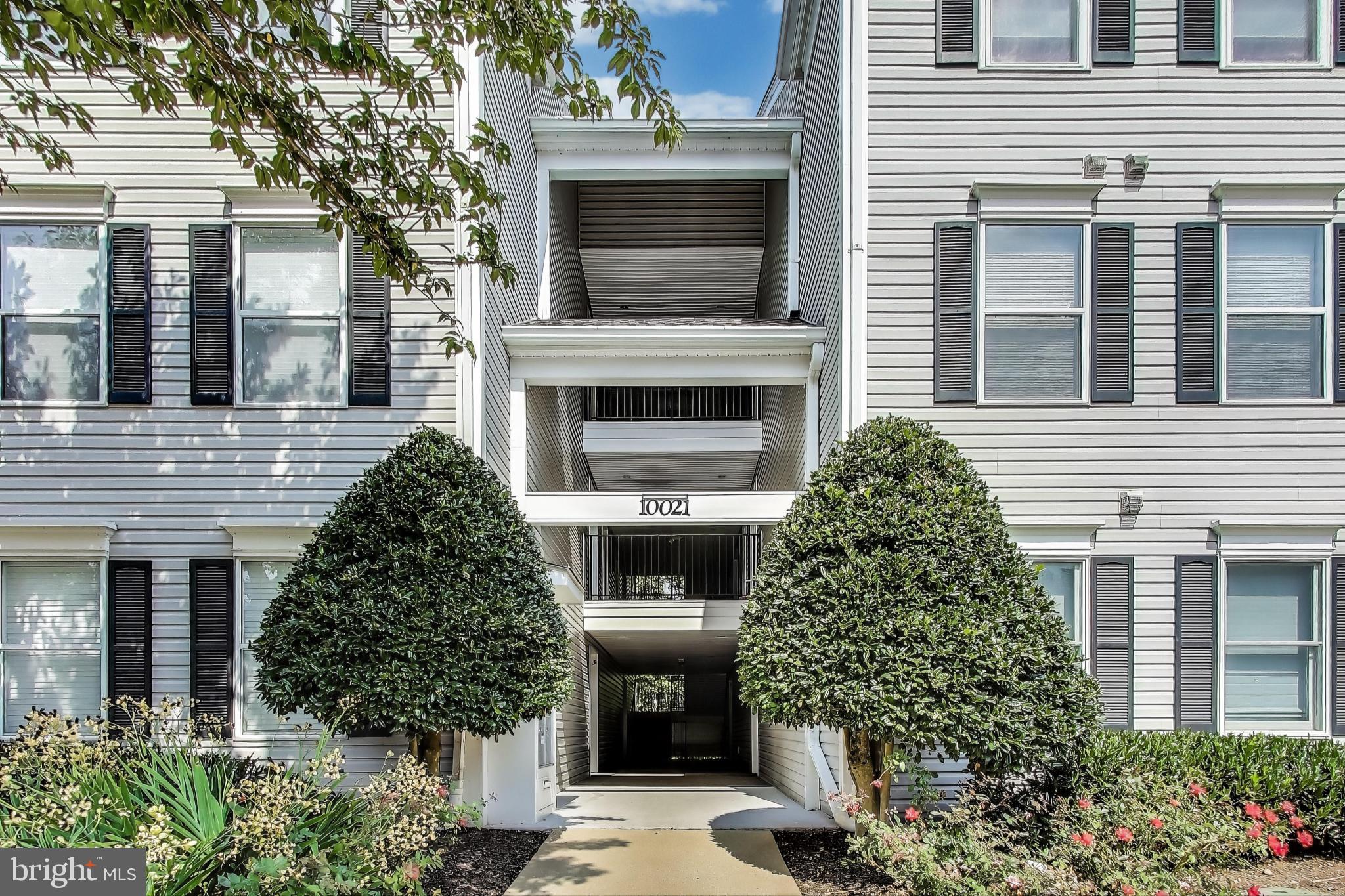 10021 Vanderbilt Circle, Unit 14 Rockville, MD 20850 - Photo 1 of 31 a front view of a house with a yard