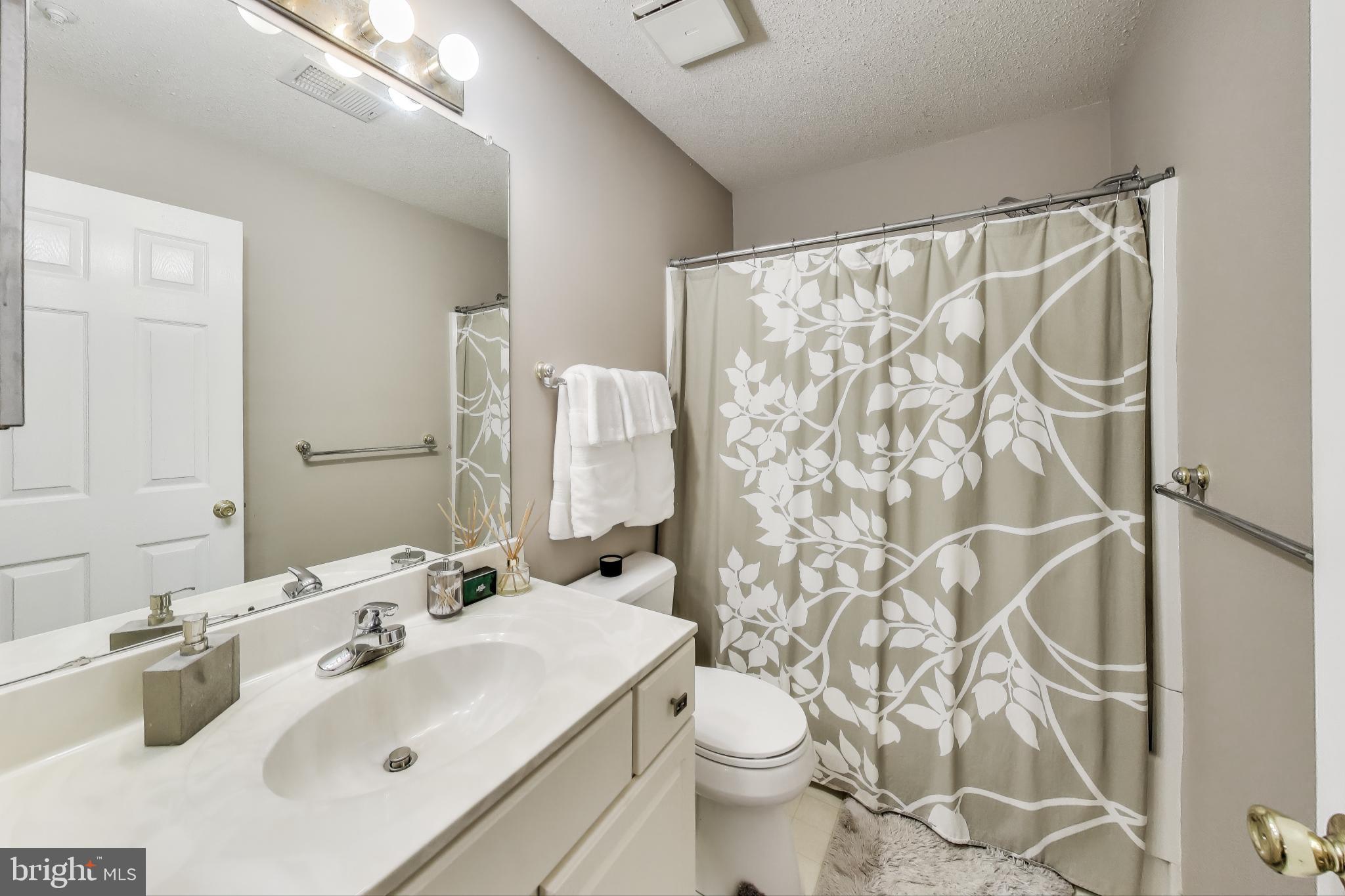 10021 Vanderbilt Circle, Unit 14 Rockville, MD 20850 - Photo 12 of 31 a bathroom with a sink toilet and shower