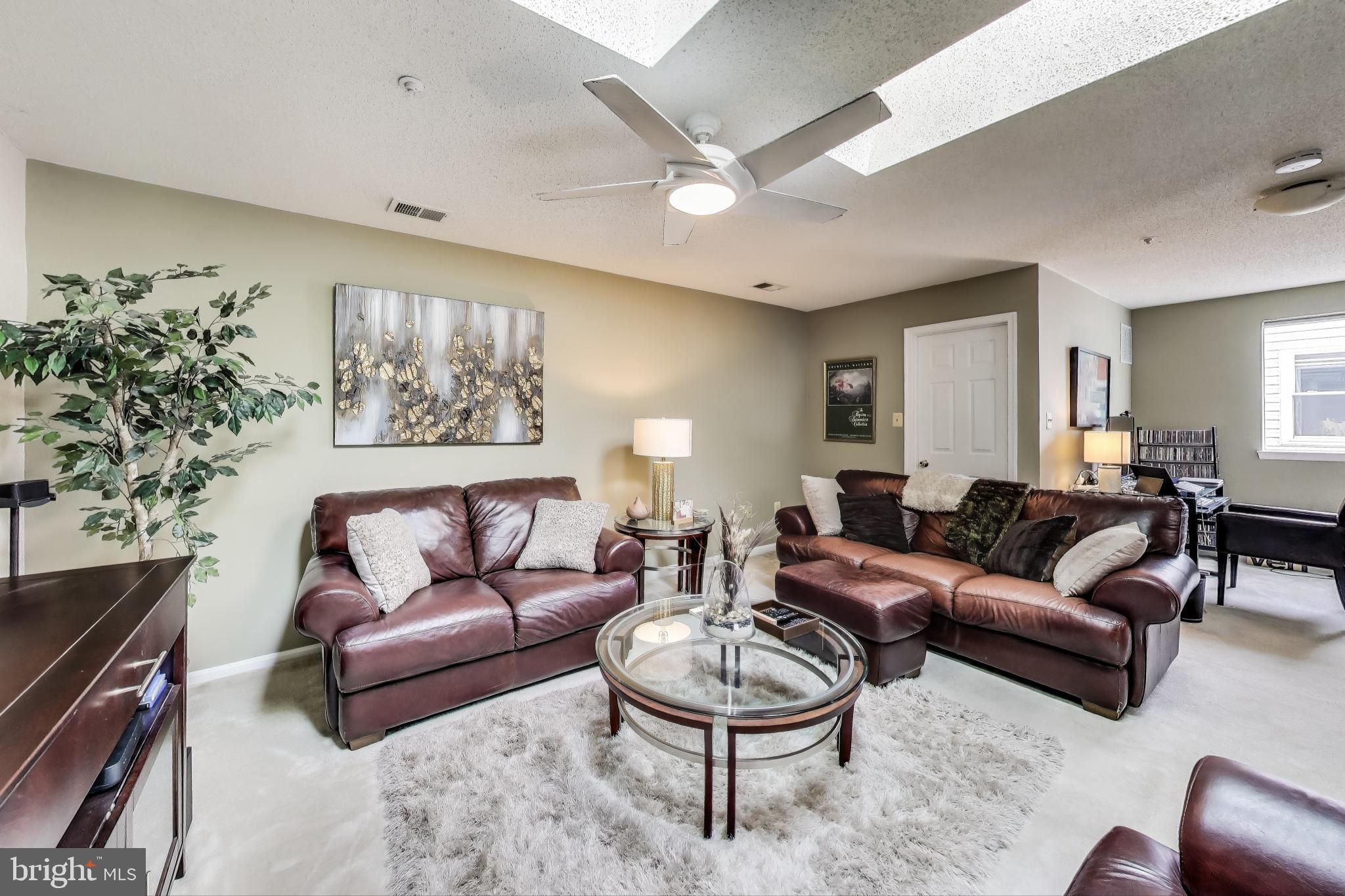 10021 Vanderbilt Circle, Unit 14 Rockville, MD 20850 - Photo 21 of 31 a living room with furniture and a large window