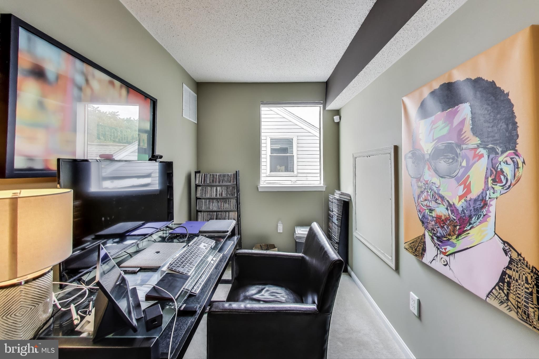 10021 Vanderbilt Circle, Unit 14 Rockville, MD 20850 - Photo 23 of 31 a bed room with a bed and a couch