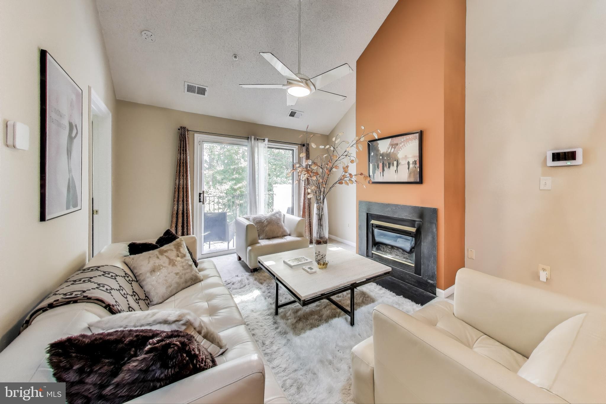 10021 Vanderbilt Circle, Unit 14 Rockville, MD 20850 - Photo 5 of 31 a living room with furniture and a fireplace