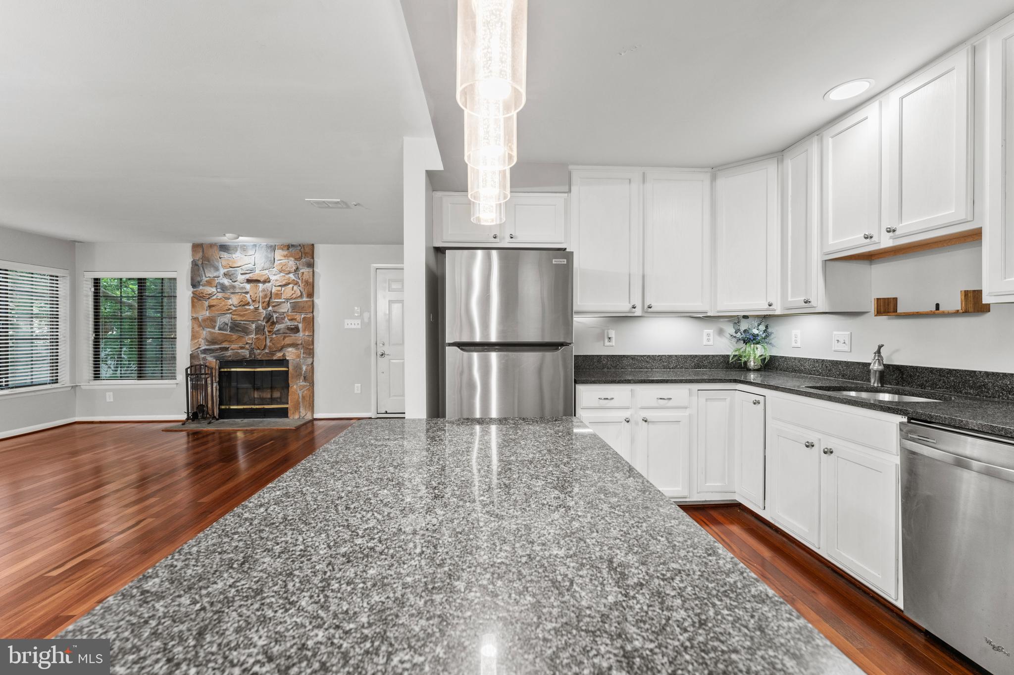 3421 Hewitt Avenue, Unit 2202 Silver Spring, MD 20906 - Photo 16 of 31 a kitchen with granite countertop a refrigerator and a sink