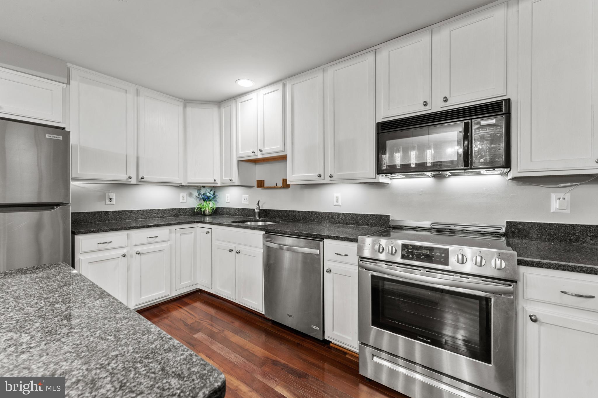 3421 Hewitt Avenue, Unit 2202 Silver Spring, MD 20906 - Photo 17 of 31 a kitchen with granite countertop cabinets stainless steel appliances and wooden floor