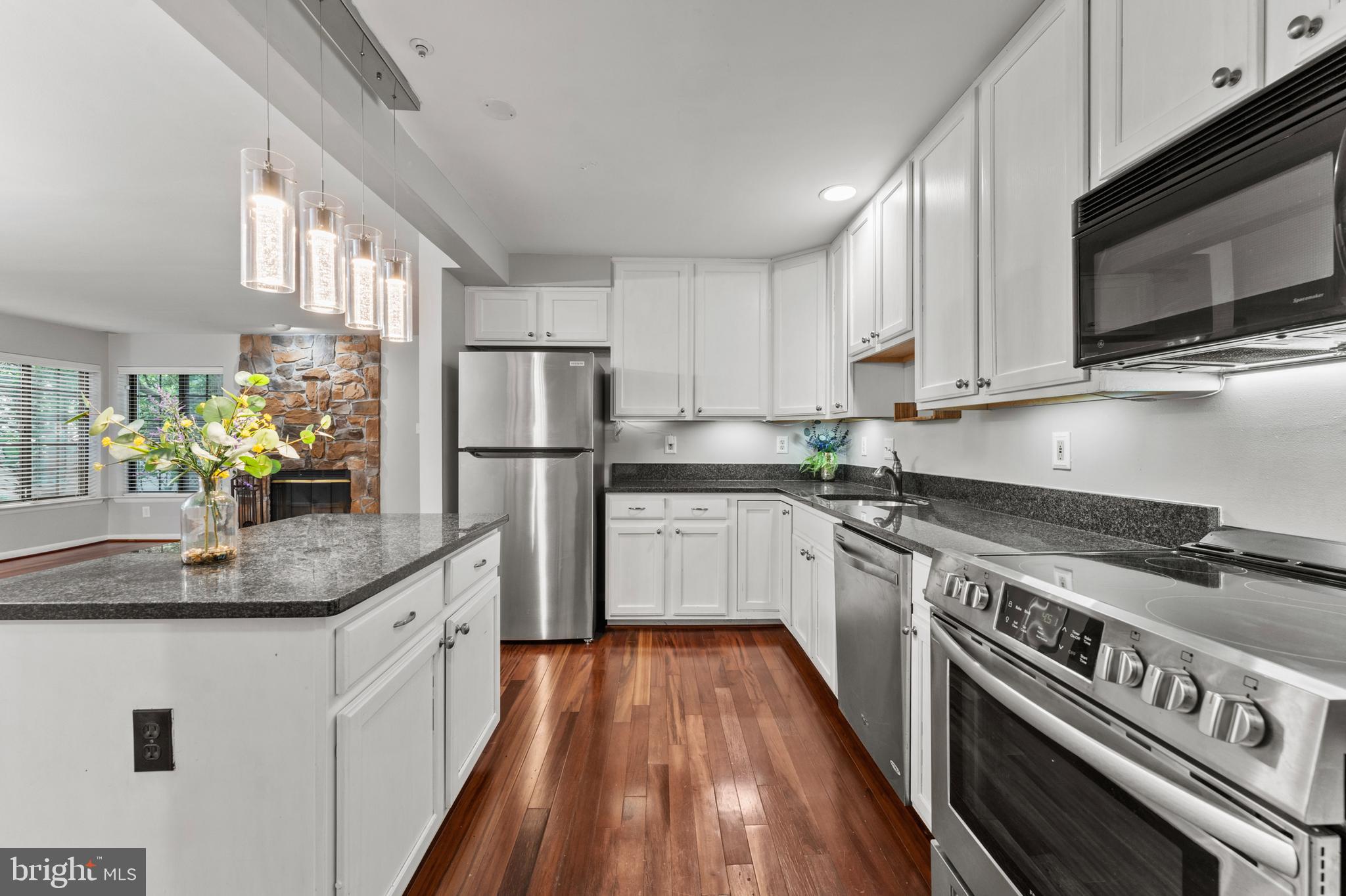 3421 Hewitt Avenue, Unit 2202 Silver Spring, MD 20906 - Photo 18 of 31 a kitchen with stainless steel appliances granite countertop a stove a sink and a refrigerator