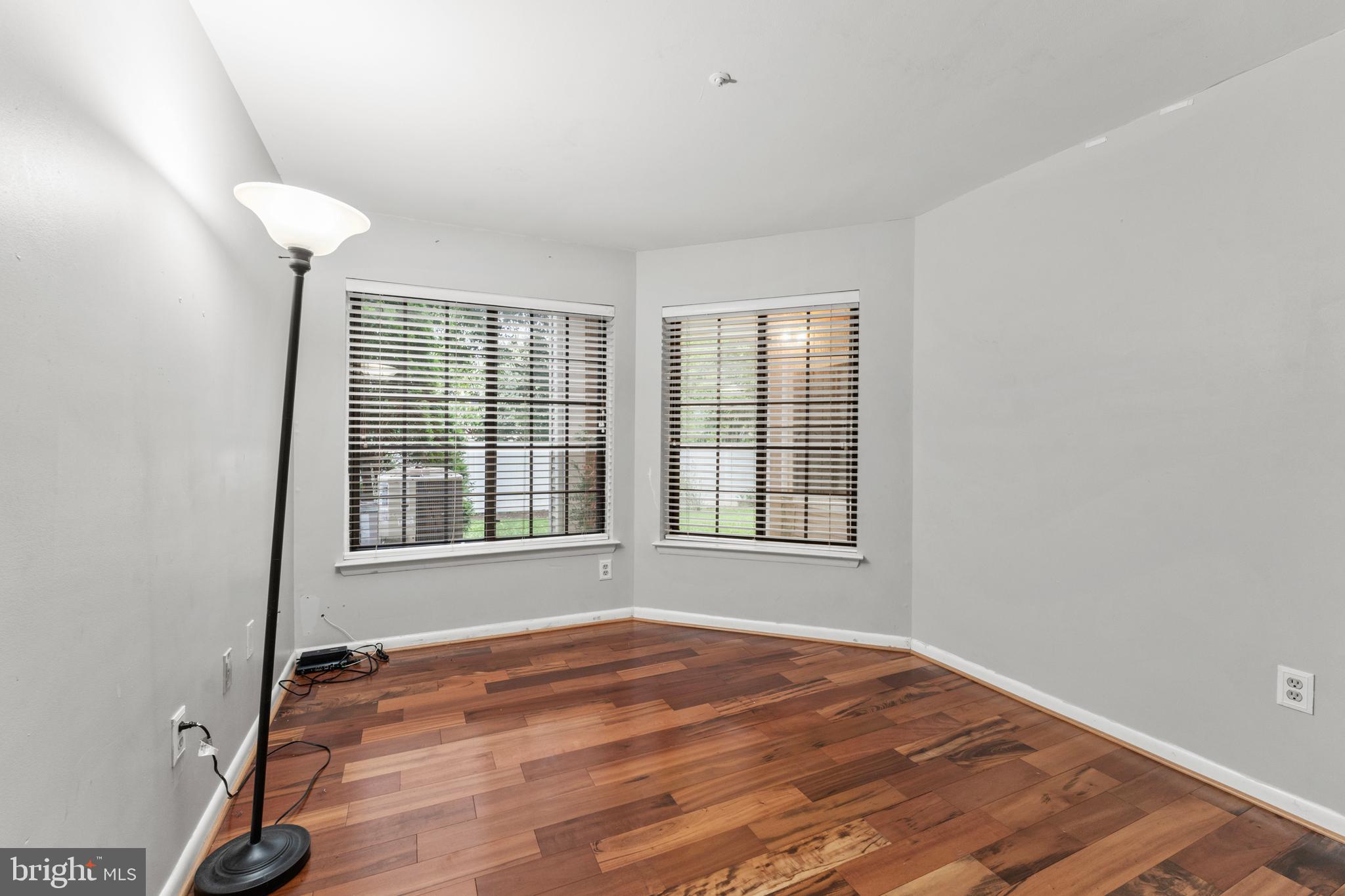 3421 Hewitt Avenue, Unit 2202 Silver Spring, MD 20906 - Photo 22 of 31 a view of an empty room with wooden floor and a window