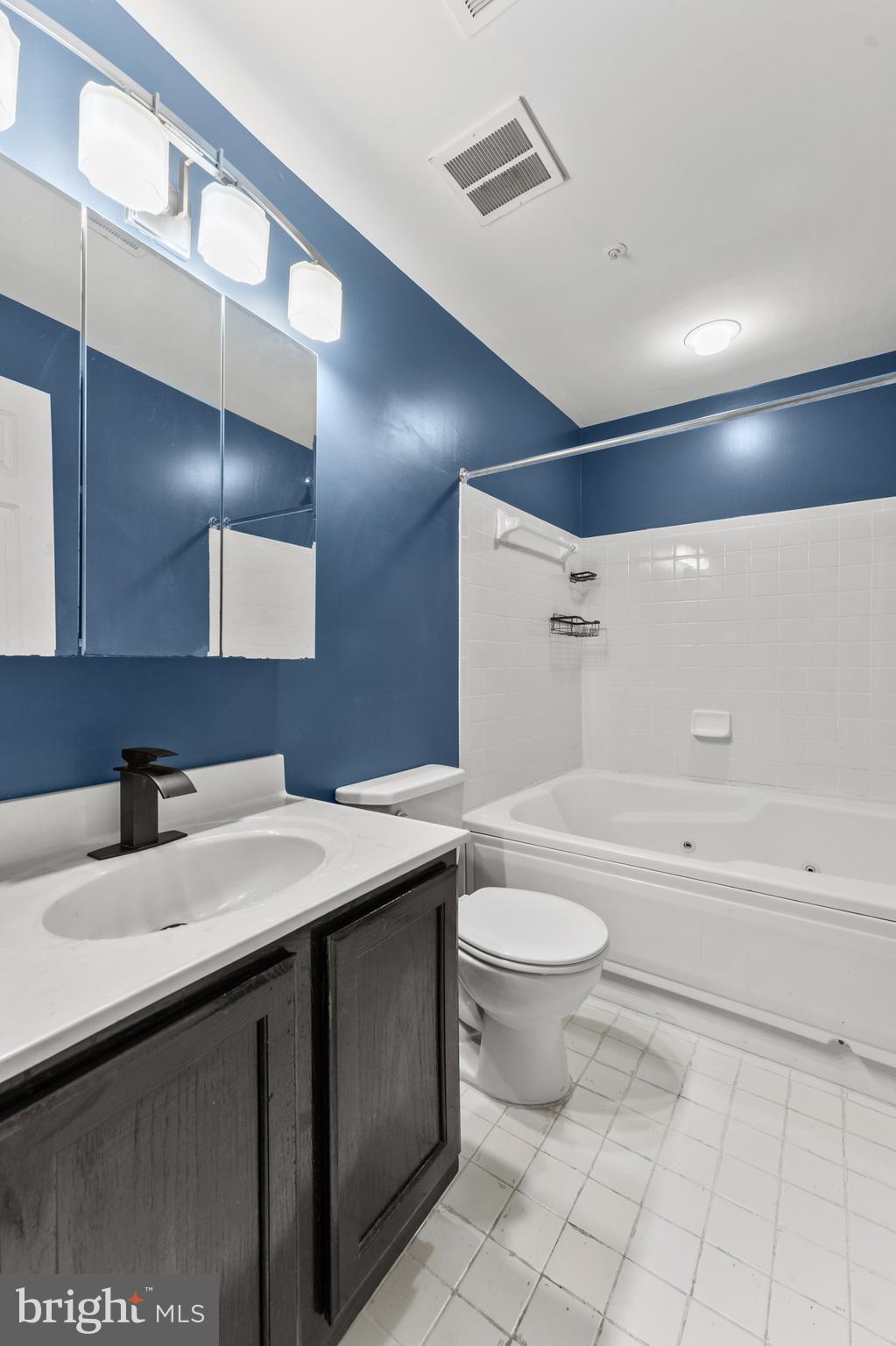 3421 Hewitt Avenue, Unit 2202 Silver Spring, MD 20906 - Photo 26 of 31 a bathroom with a sink a toilet and a bathtub