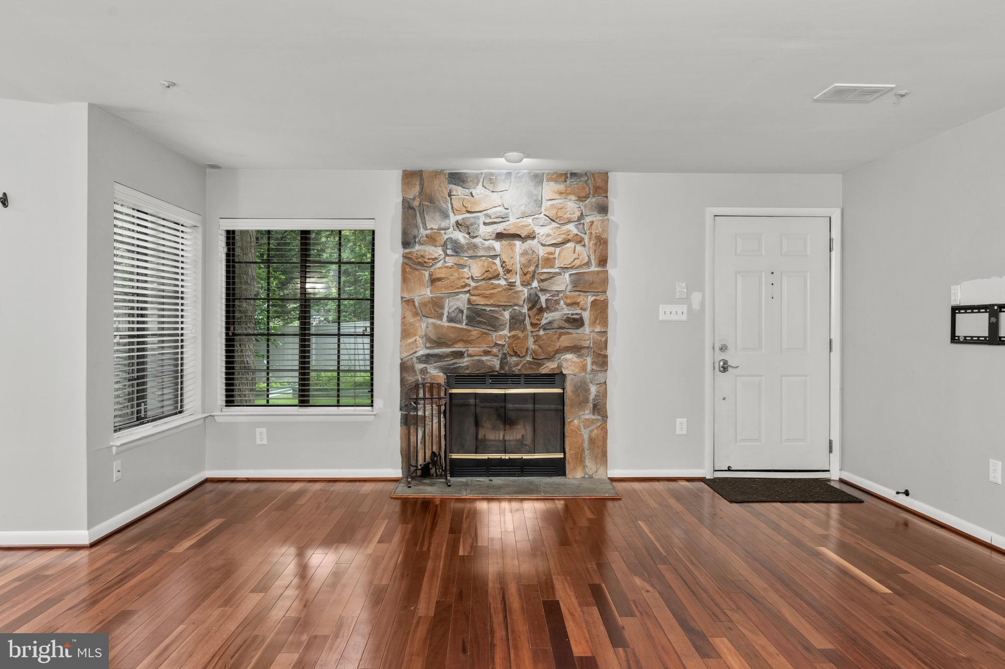 3421 Hewitt Avenue, Unit 2202 Silver Spring, MD 20906 - Photo 6 of 31 an empty room with wooden floor fire place and windows