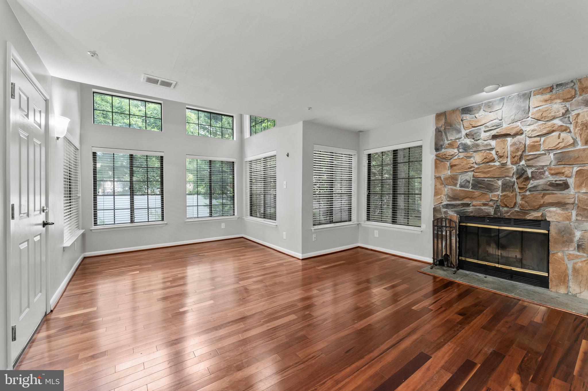3421 Hewitt Avenue, Unit 2202 Silver Spring, MD 20906 - Photo 7 of 31 a view of an empty room with wooden floor and a window