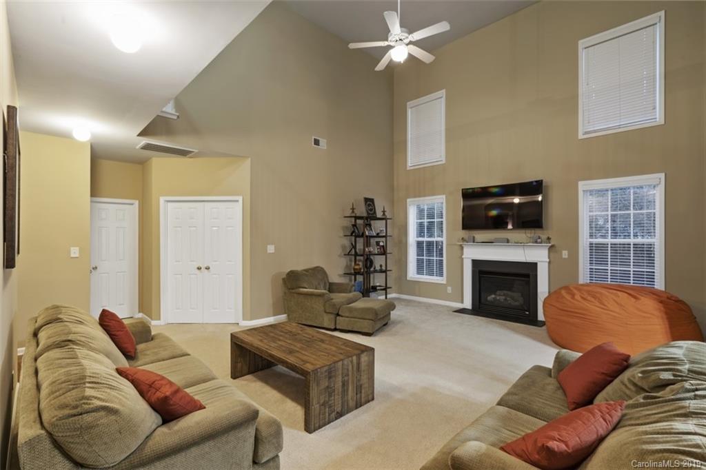 1559 Broderick Street Northwest Concord, NC 28027 - Photo 14 of 29 a living room with furniture a fireplace and a flat screen tv