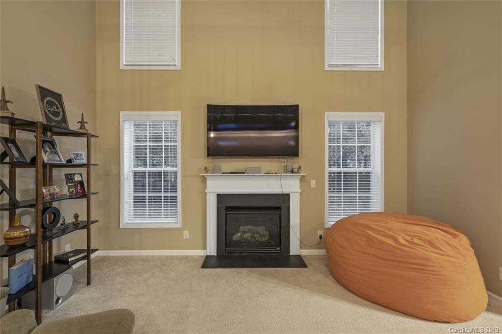 1559 Broderick Street Northwest Concord, NC 28027 - Photo 15 of 29 a living room with furniture a fireplace and a window