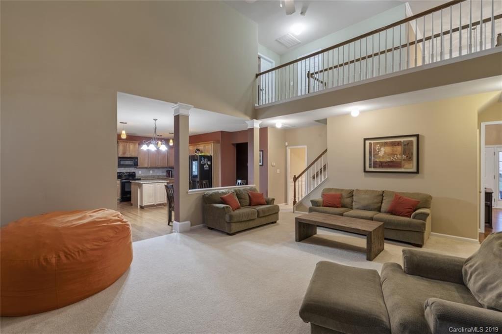 1559 Broderick Street Northwest Concord, NC 28027 - Photo 16 of 29 a living room with furniture and a wooden floor