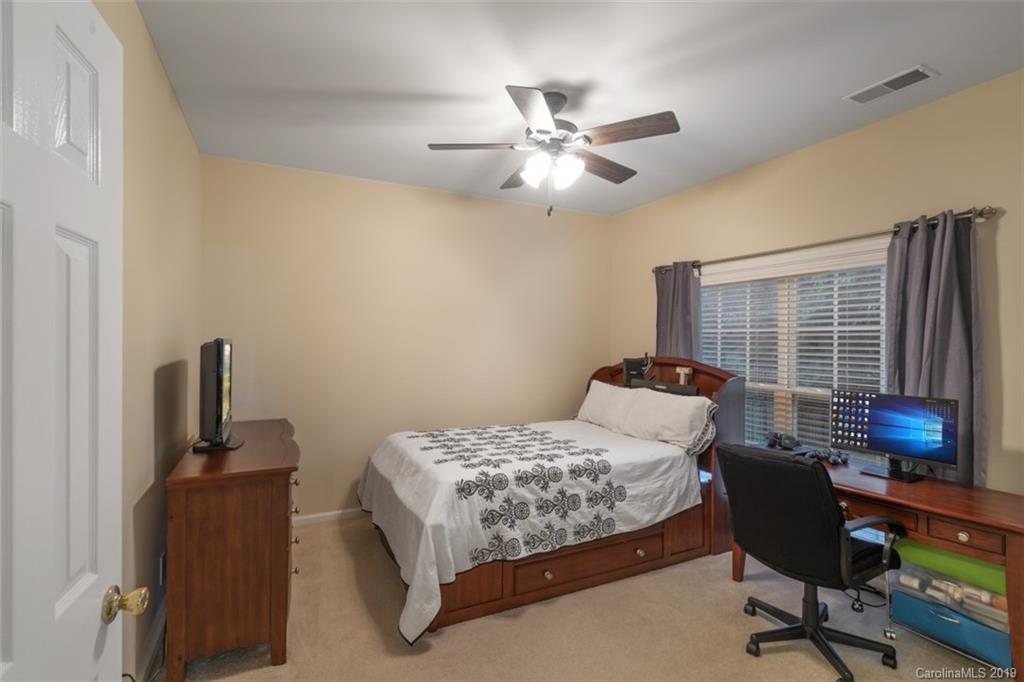 1559 Broderick Street Northwest Concord, NC 28027 - Photo 18 of 29 a bedroom with a bed and a window