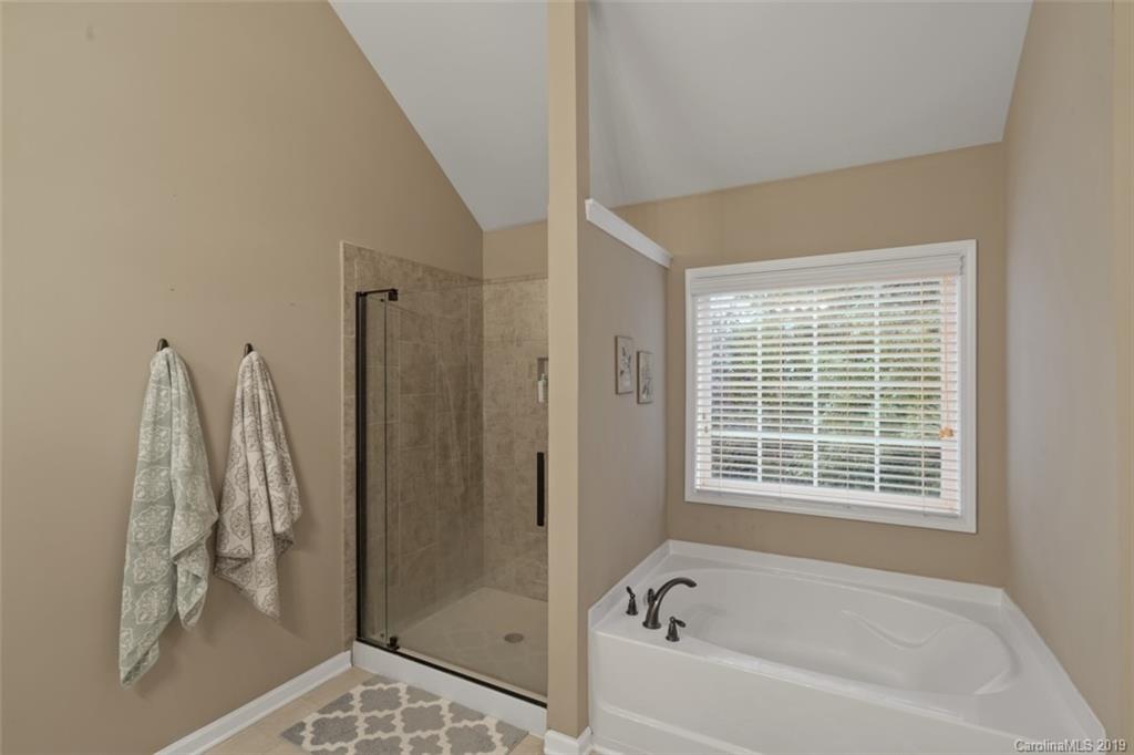 1559 Broderick Street Northwest Concord, NC 28027 - Photo 20 of 29 a bathroom with a bathtub and a shower
