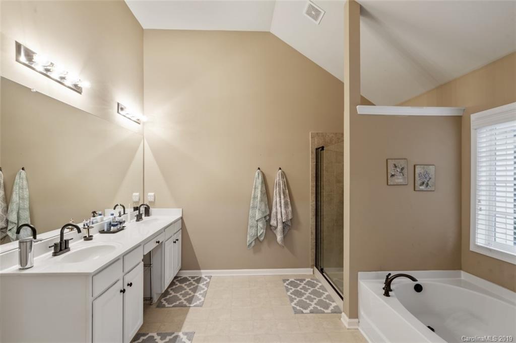 1559 Broderick Street Northwest Concord, NC 28027 - Photo 22 of 29 a bathroom with a tub sink and mirror