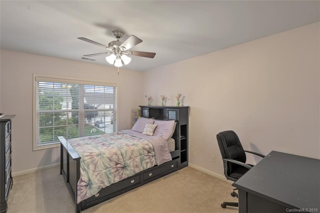 1559 Broderick Street Northwest Concord, NC 28027 - Photo 26 of 29 a bedroom with a bed and a desk