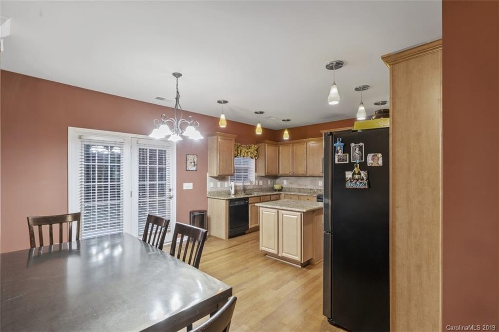 1559 Broderick Street Northwest Concord, NC 28027 - Photo 10 of 29 a kitchen with stainless steel appliances granite countertop a stove refrigerator and chairs
