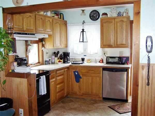 29 Partridge Road Weymouth, MA 02190 - Photo 3 of 15 a kitchen with stainless steel appliances granite countertop a stove a sink and a refrigerator with wooden cabinets