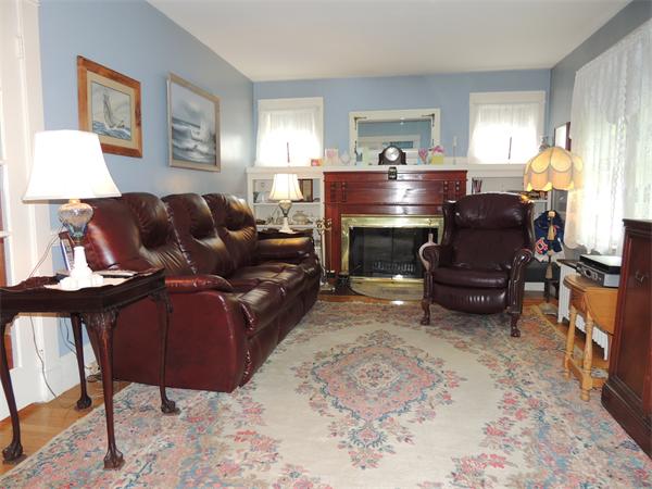29 Partridge Road Weymouth, MA 02190 - Photo 5 of 15 a living room with furniture a fireplace and a window
