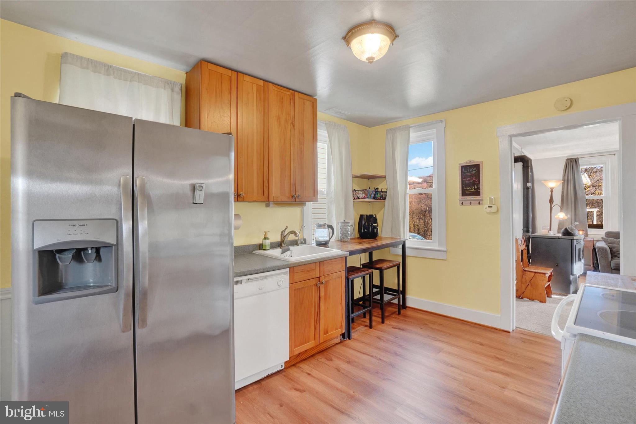 48 High Street Felton, PA 17322 - Photo 10 of 28 a kitchen with stainless steel appliances granite countertop a refrigerator a stove and a wooden floors