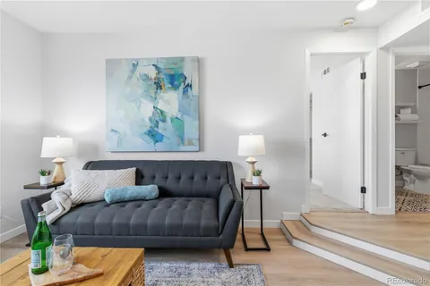 a living room with furniture and a lamp