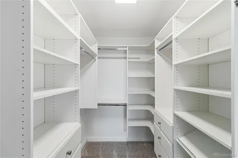 a view of walk in closet with empty racks