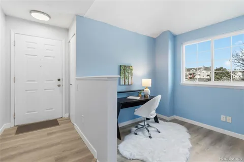 a workspace with wooden floor and a window