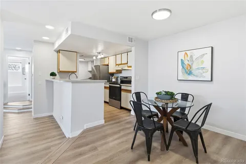 a view of a dining room with furniture and wooden floor
