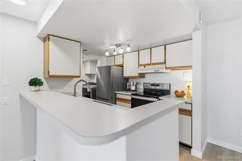 a kitchen with stainless steel appliances a sink a stove and a refrigerator