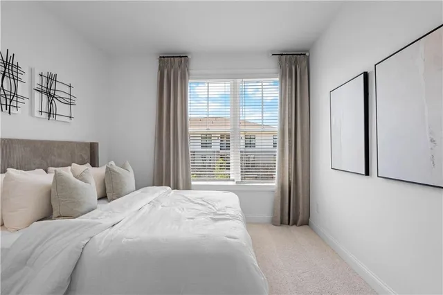a large bed sitting in a bedroom next to a window